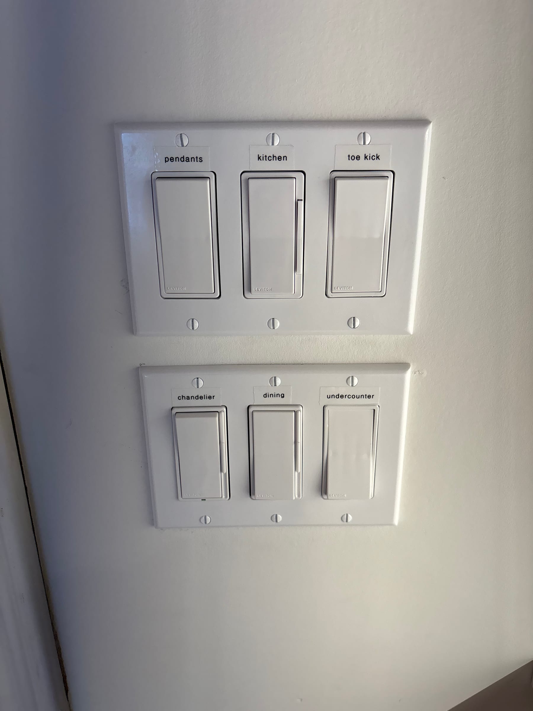 Custom-labeled Lutron dimmer switches for pendants, kitchen and chandelier by Call Paul Contracting, Edmonton
