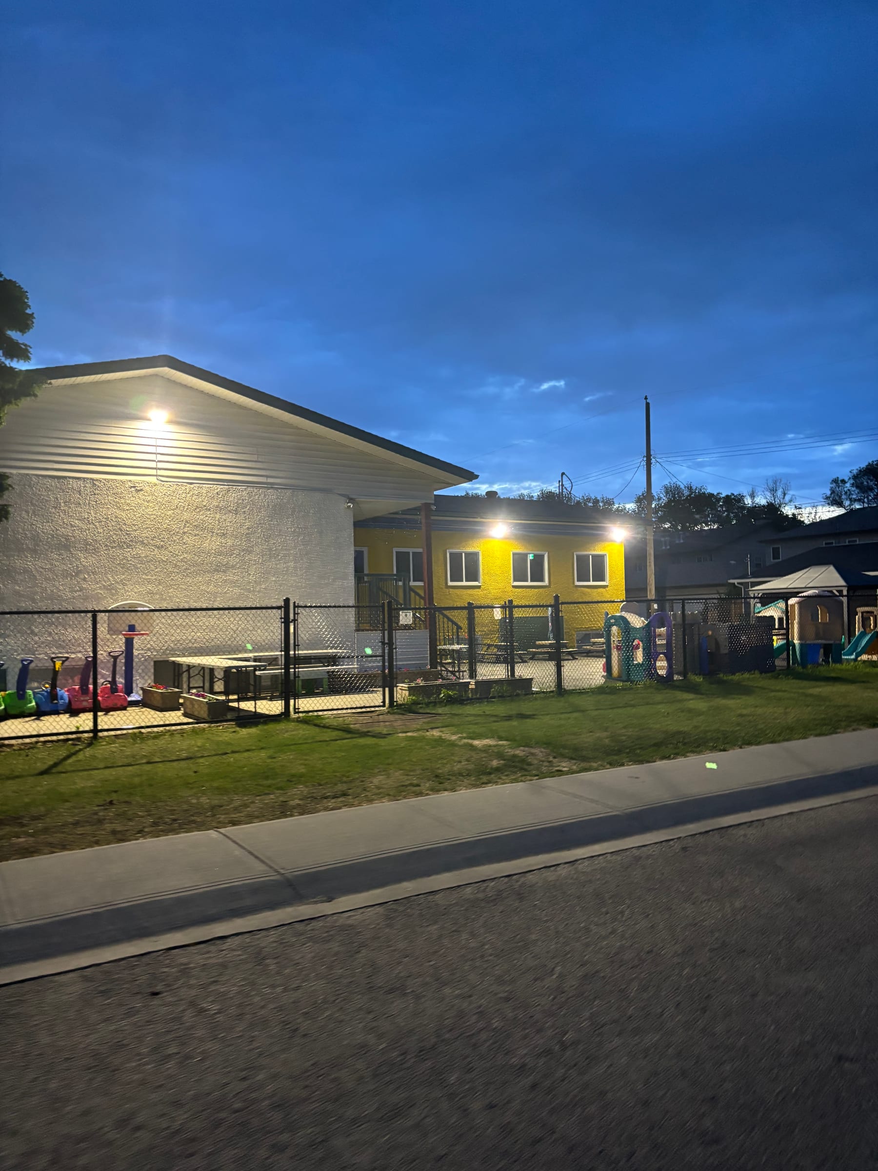 Commercial daycare exterior and site lighting at dusk by Call Paul Contracting, Edmonton