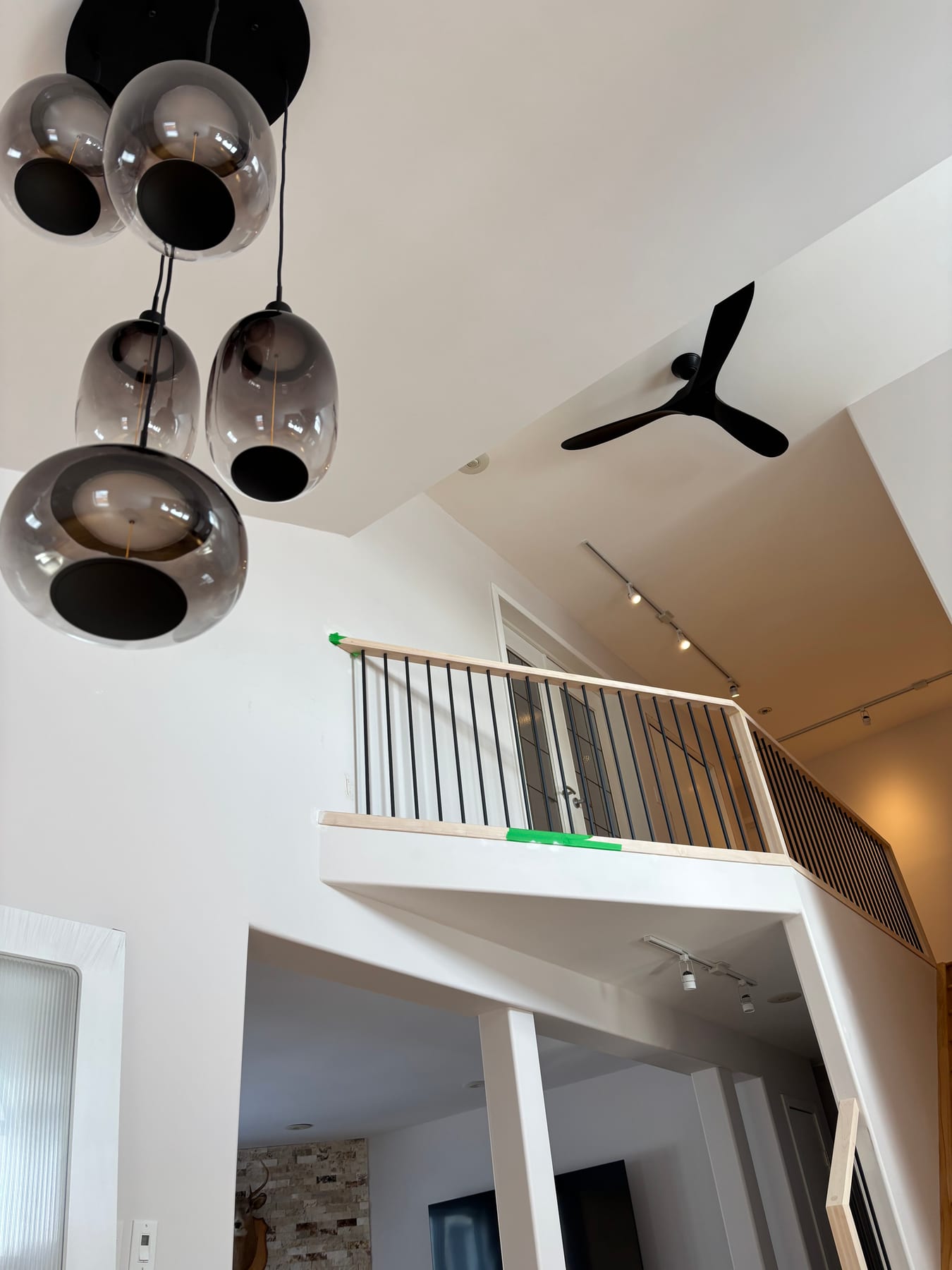 Smoked-glass orb pendant lights and a black ceiling fan installed by Call Paul Contracting in Edmonton