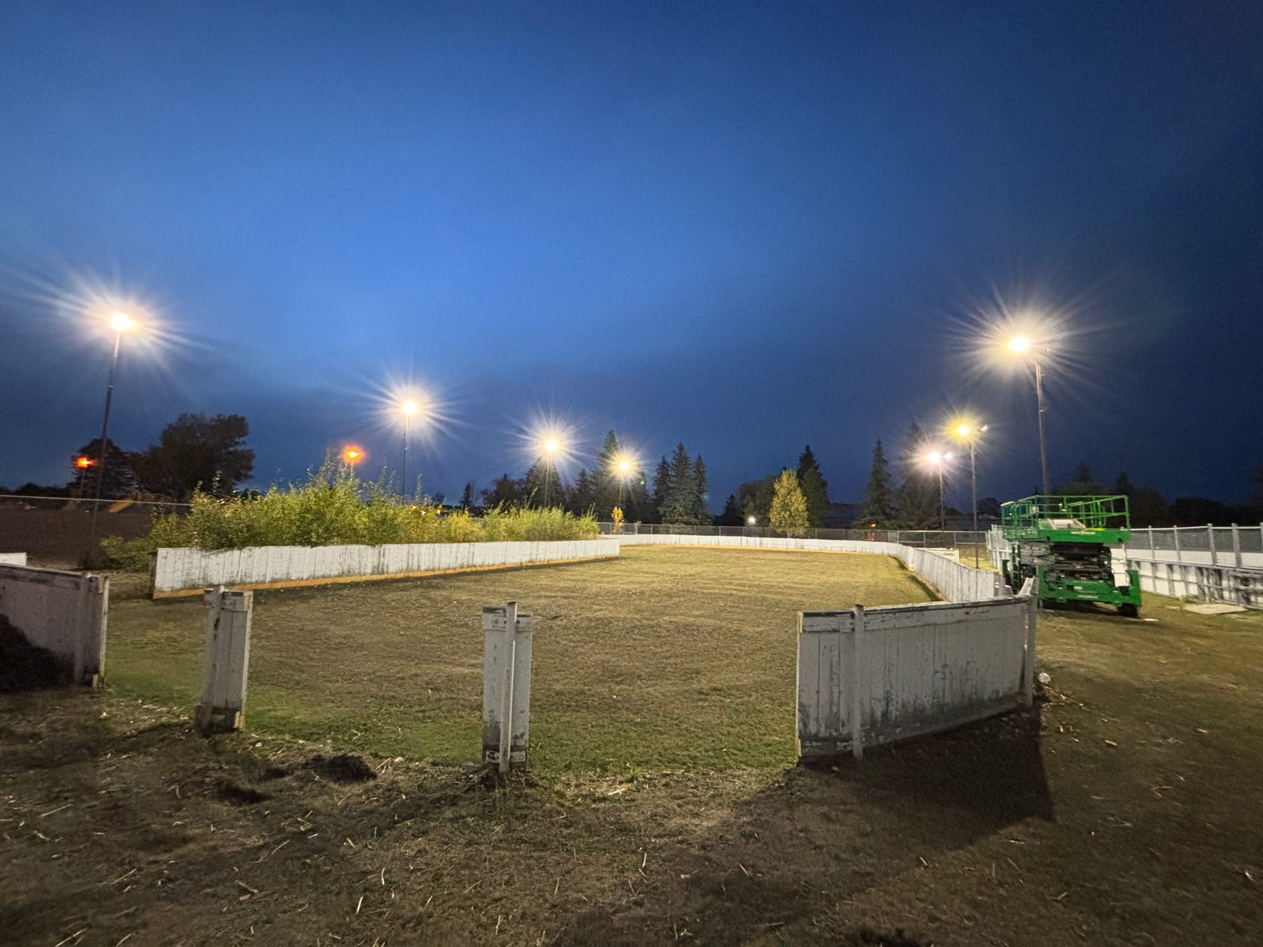 Outdoor arena rink floodlights serviced at dusk by Call Paul Contracting, Edmonton