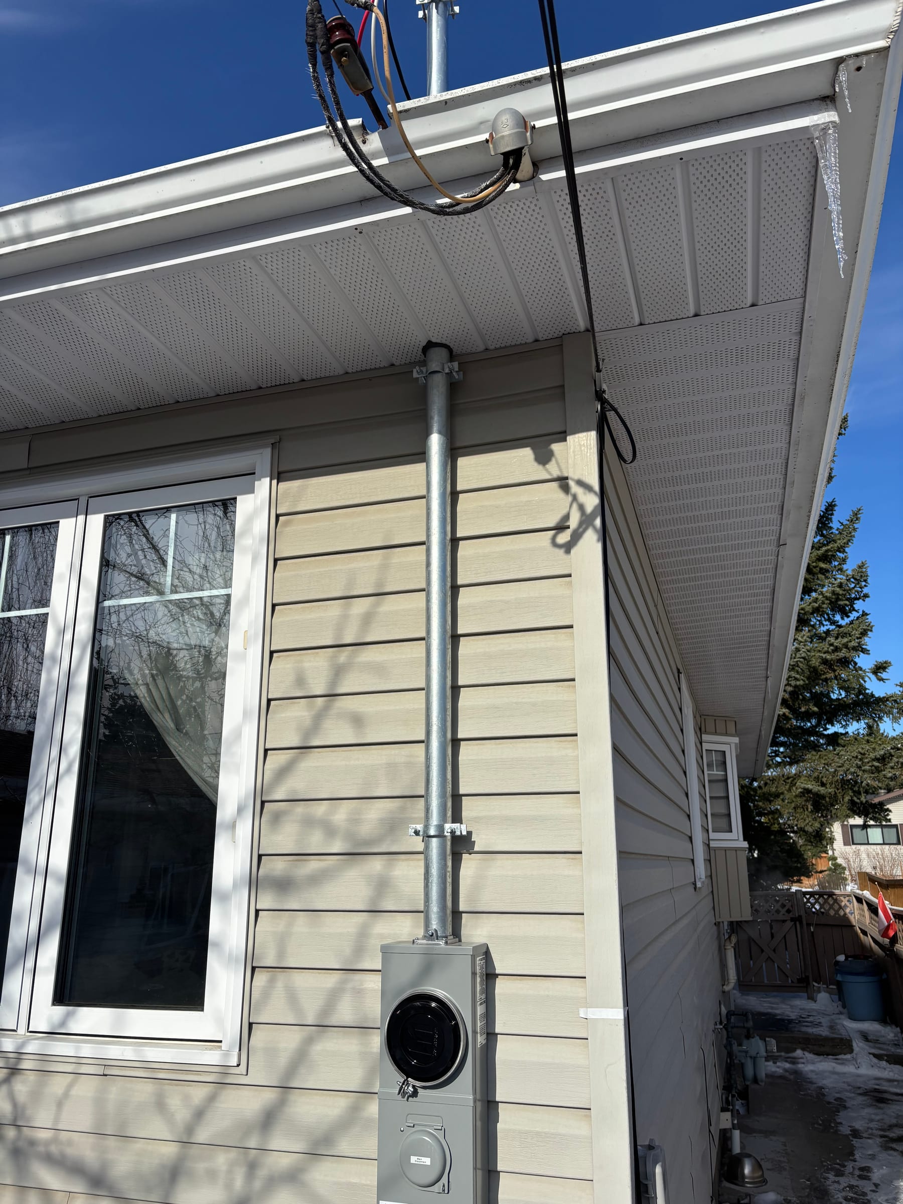 Overhead service drop, mast and meter socket upgrade on a home by Call Paul Contracting, Edmonton