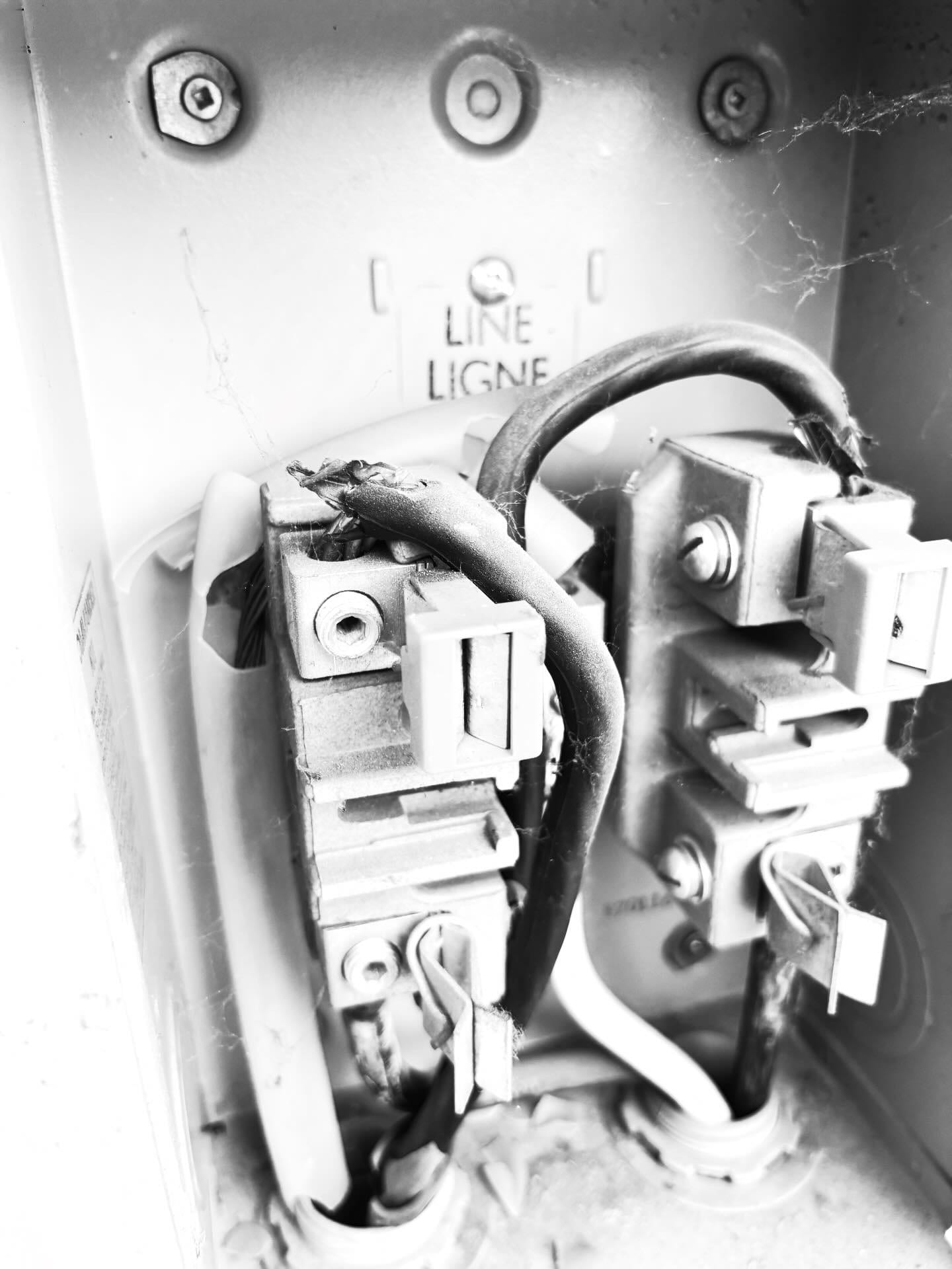 Burnt and damaged wiring found at a meter base during a safety inspection by Call Paul Contracting, Edmonton