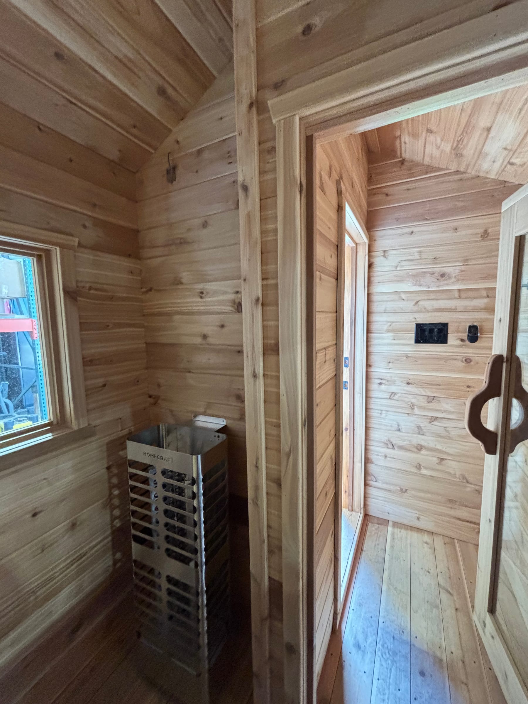 Cedar sauna interior with heater wired by Call Paul Contracting, Edmonton