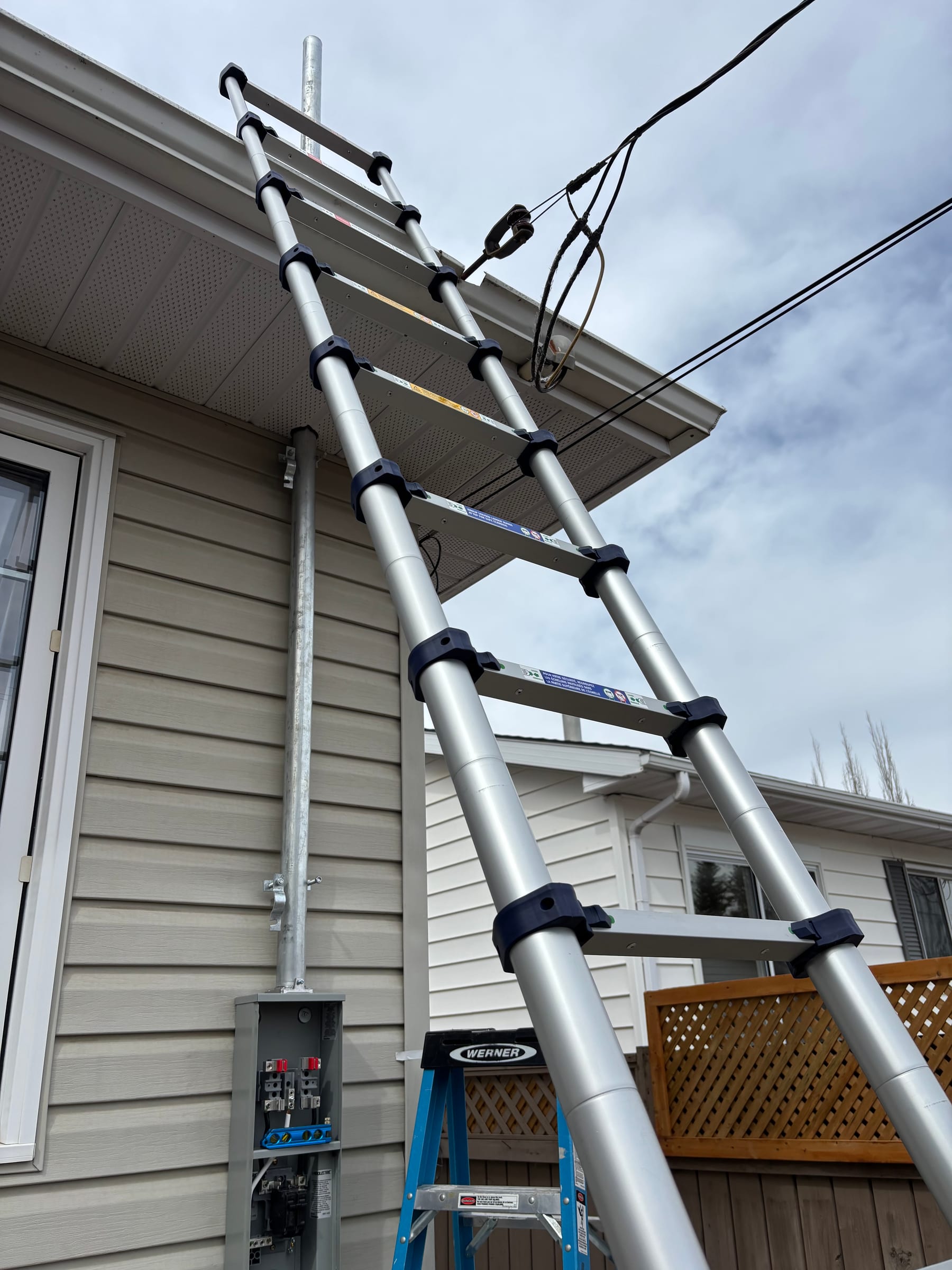Exterior service mast conduit run installed by Call Paul Contracting, Edmonton